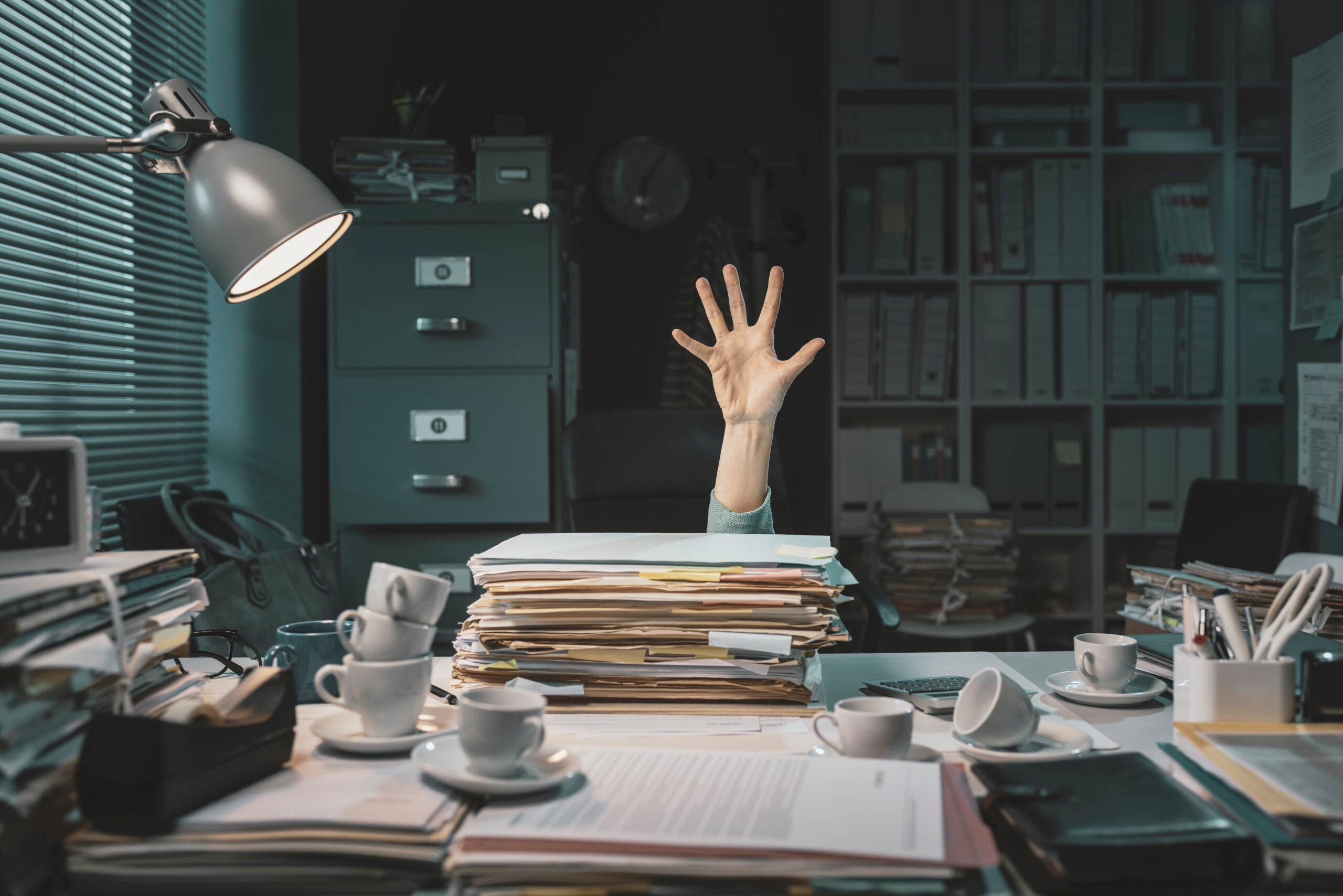 Desperate office worker overwhelmed with paperwork, she is asking help with her hand